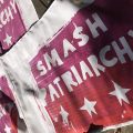 A series of posters on a wall saying "Smash Patriarchy"